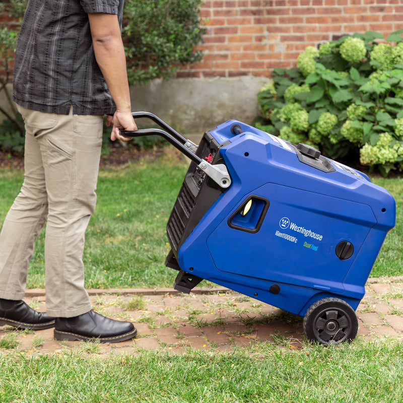 Westinghouse | iGen11000DFc dual fuel portable inverter generator with co sensor shown being pushed in front of a house