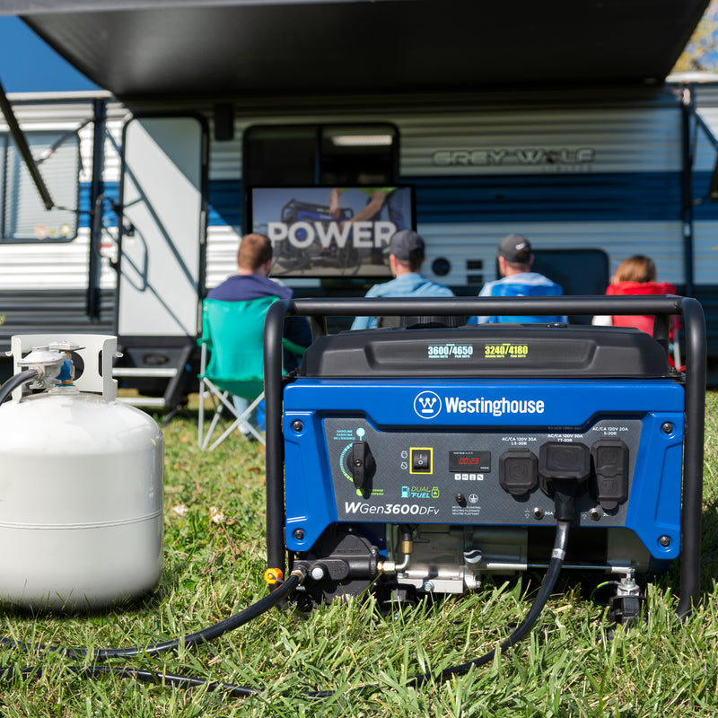 Westinghouse | WGen3600DFv portable generator hooked up to a propane tank. There are peopling sitting in the background in front of a camper watching tv. 