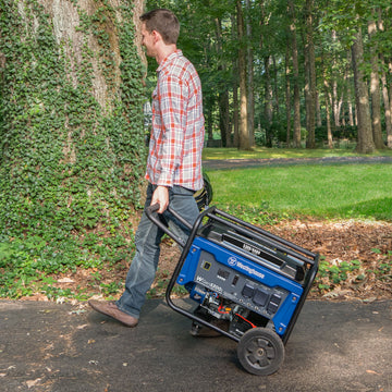 Westinghouse | WGen5300s portable generator being wheeled down a driveway.