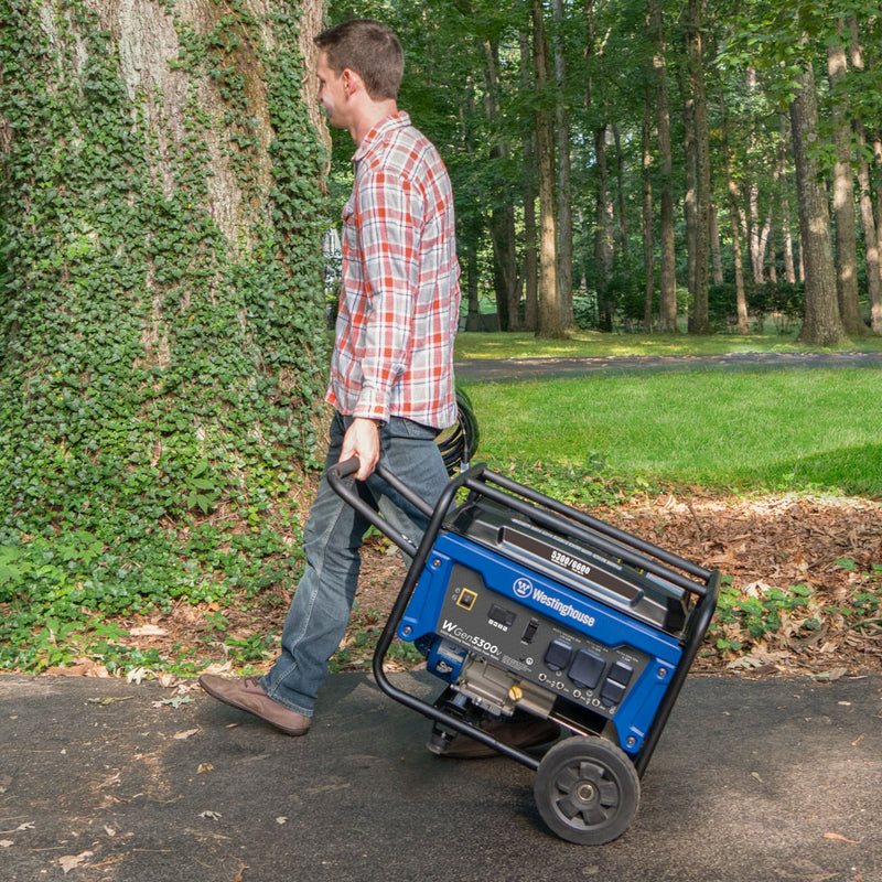 Westinghouse | WGen5300v portable generator being wheeled down a driveway.