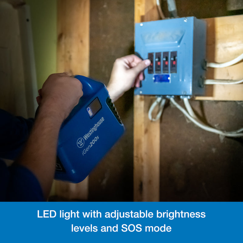 Westinghouse | iGen200s Portable Power Station flashlight feature being used to illuminate a box of circuit breakers. A blue banner along the bottom reads, 