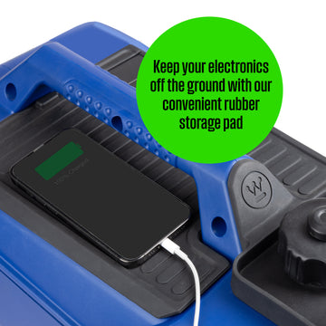 Westinghouse | iGen2550 portable inverter generator showing a phone being charged and sitting on the storage pad on the generator with words saying: keep your electronics off the ground with our convenient rubber storage pads